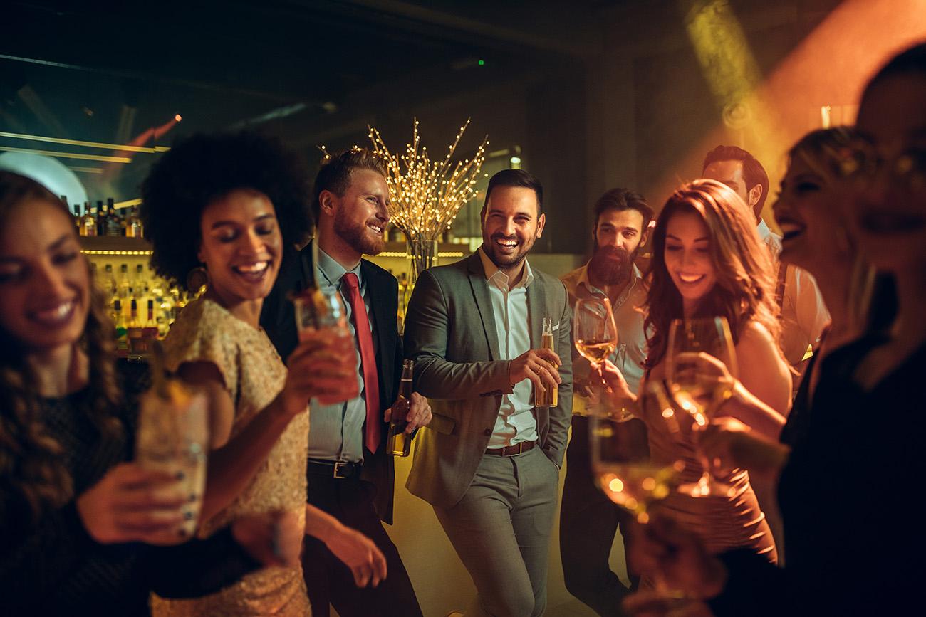 A group of friends having the best time drinking champagne and laughing