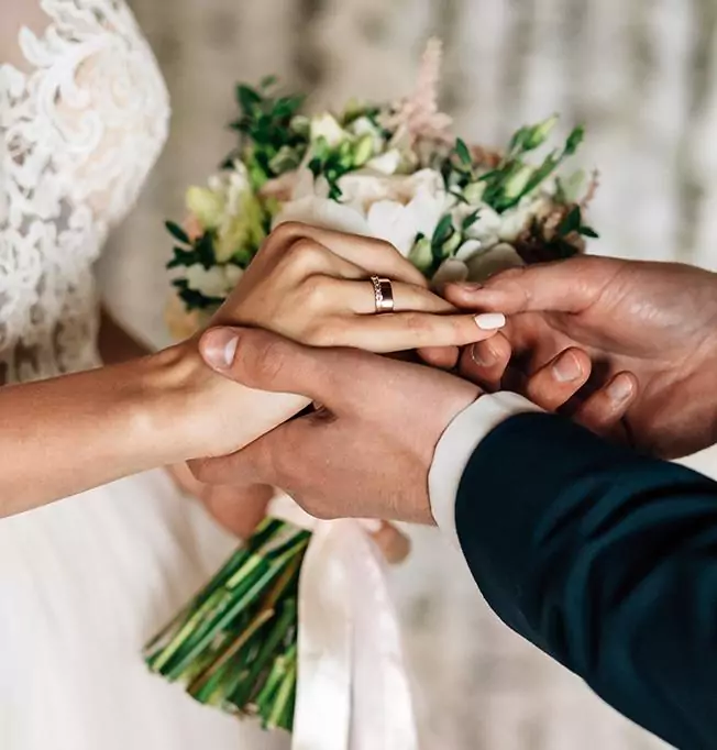 Man placing ring on woman's finger - The Tower Hotel