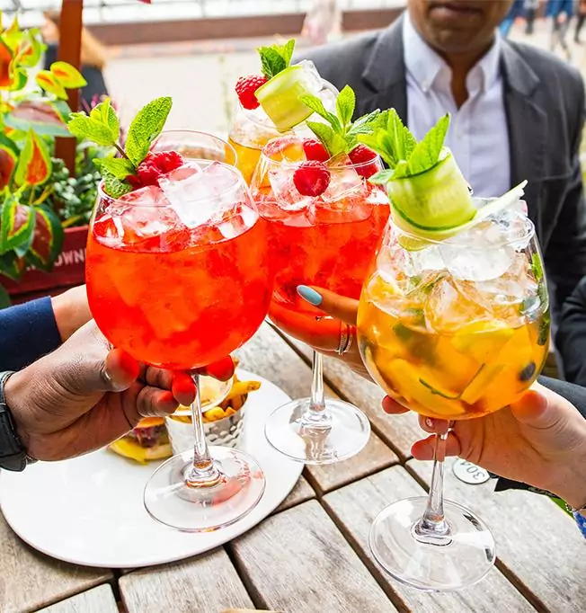 Group clinking glasses of Pimms - The Tower Hotel