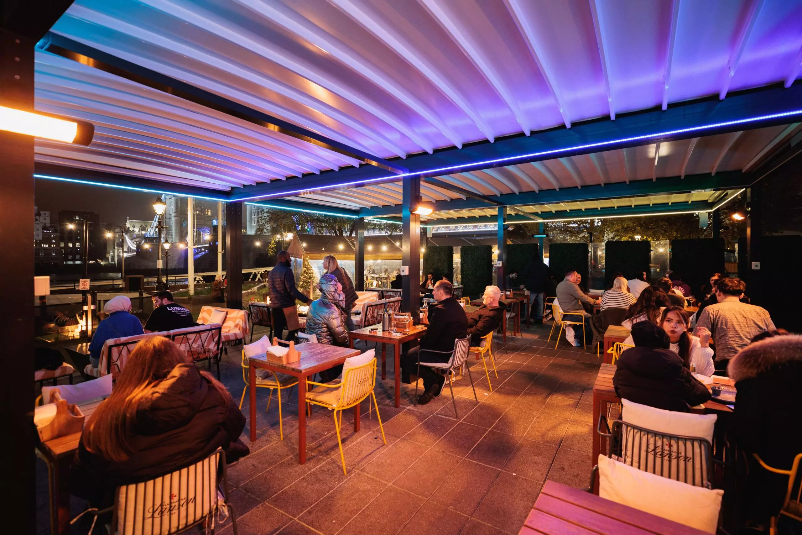 People enjoying drinks on a restaurant terrace in winter