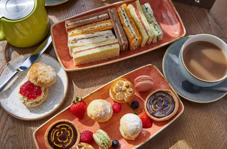 Selection of afternoon tea cakes and sandwiches