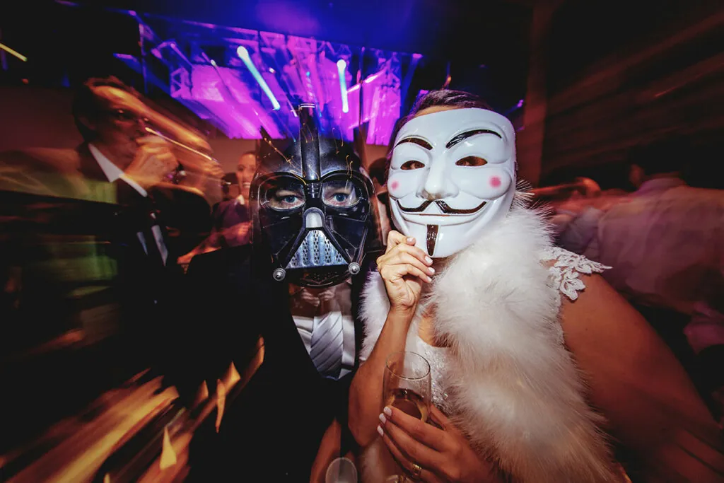 Two people in masks at a Halloween Party